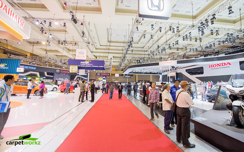 Car exhibition with a red carpet