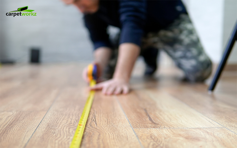 guy measuring the floor